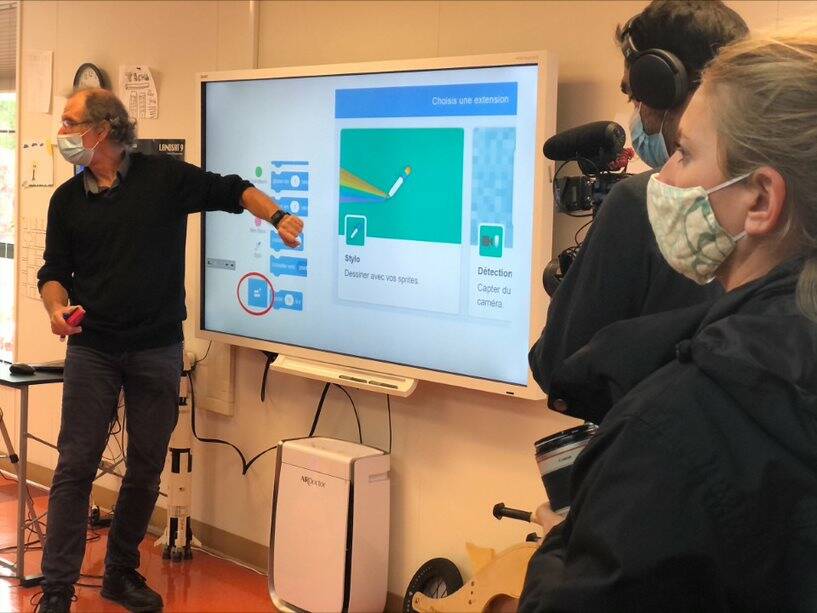 Technology teacher Fabrice Gunther teaches a lesson to fifth-grade students with the film crew off to the right. Photo courtesy of the French American School of Puget Sound