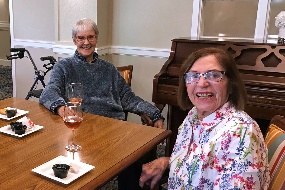 Suzanne and Pat enjoying a drink at Island House MBK Senior Living. To book a tour or try a taste of the MBK cuisine, call 206-347-8168.