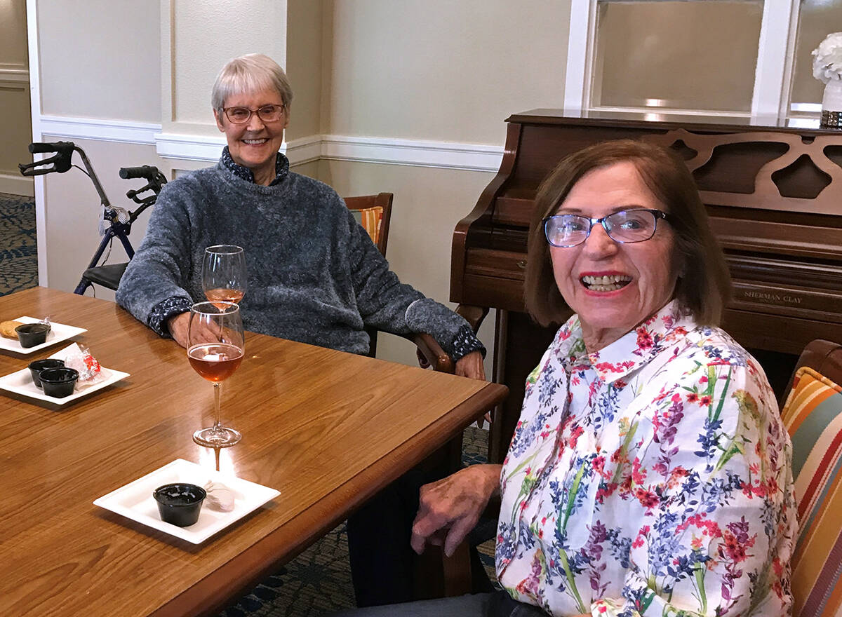 Suzanne and Pat enjoying a drink at Island House MBK Senior Living. To book a tour or try a taste of the MBK cuisine, call 206-209-0768.