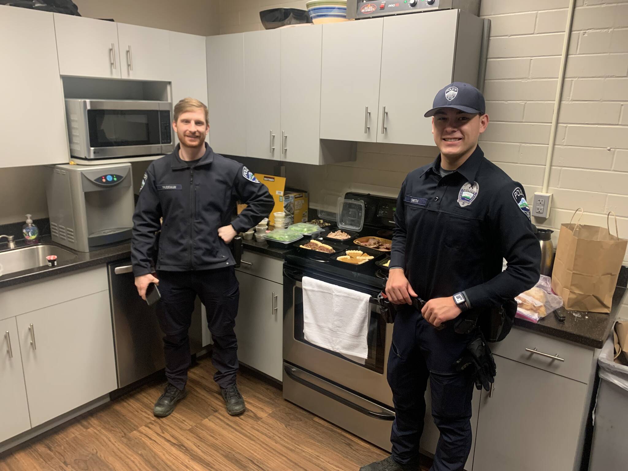 A group of Mercer Island residents showed its appreciation for the Mercer Island Police Department by delivering a Thanksgiving meal to the station last week. Pictured are officers Sam Trudeaux, left, and Chris Smith. Courtesy photo