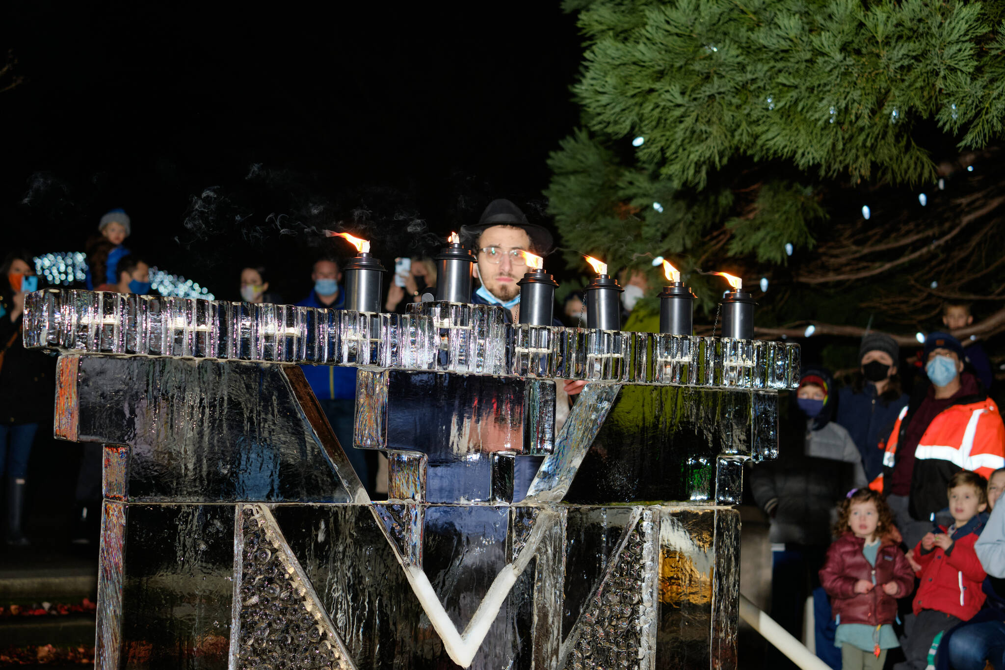 Chabad Mercer Island Director and Rabbi Nissan Kornfeld eyes the ice menorah on Dec. 2 at Mercerdale Park. Photo courtesy of James N.