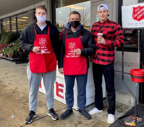 Mercer Island Police Department Chief Ed Holmes, a longtime member of the Rotary Club of Mercer Island, is flanked by his sons, Ben (left) and Andrew (right) while ringing bells to encourage donations for The Salvation Army on a recent Saturday at the south end QFC. Courtesy photo