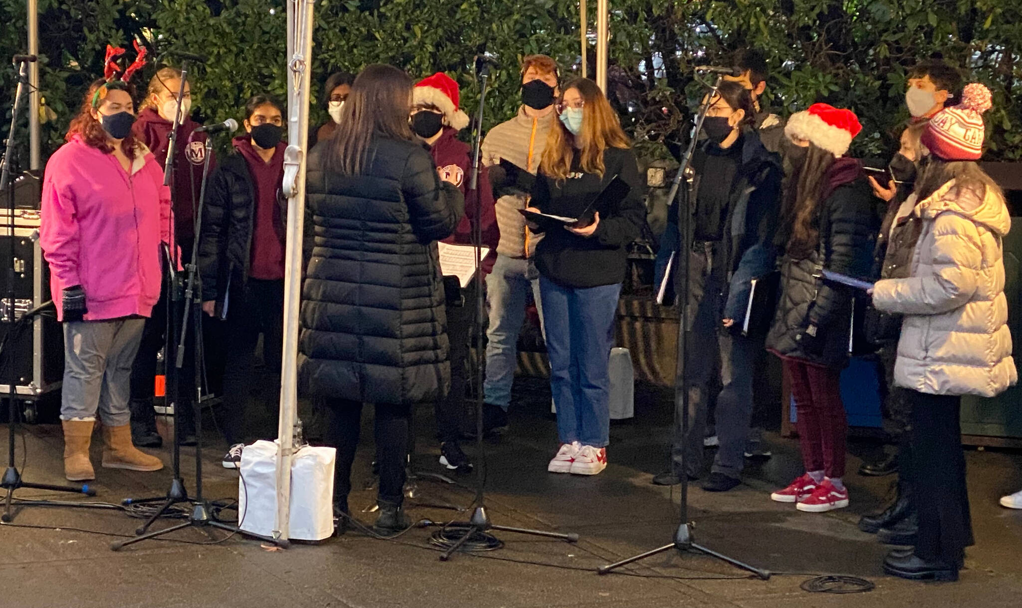 The Mercer Island High School Bel Canto Choir performs on Dec. 16 at Mercerdale Park. Following the event, the choir sang for the residents at Island House in the courtyard. Courtesy photo