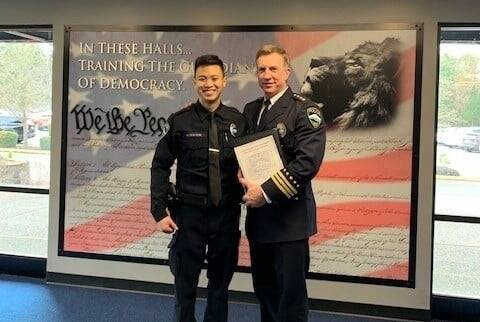 The Mercer Island Police Department recently welcomed its newest officer, Huy Nguyen, left. Last month, he graduated from the police academy, where he was greeted by Mercer Island Police Chief Ed Holmes, right. Nguyen was born and raised in Vietnam and completed school and worked in Ho Chi Minh City. Nguyen, his parents and his younger sister immigrated to the United States in 2018, and he served as an airman for the United States Air Force and now continues his military service as a reservist. Courtesy photo