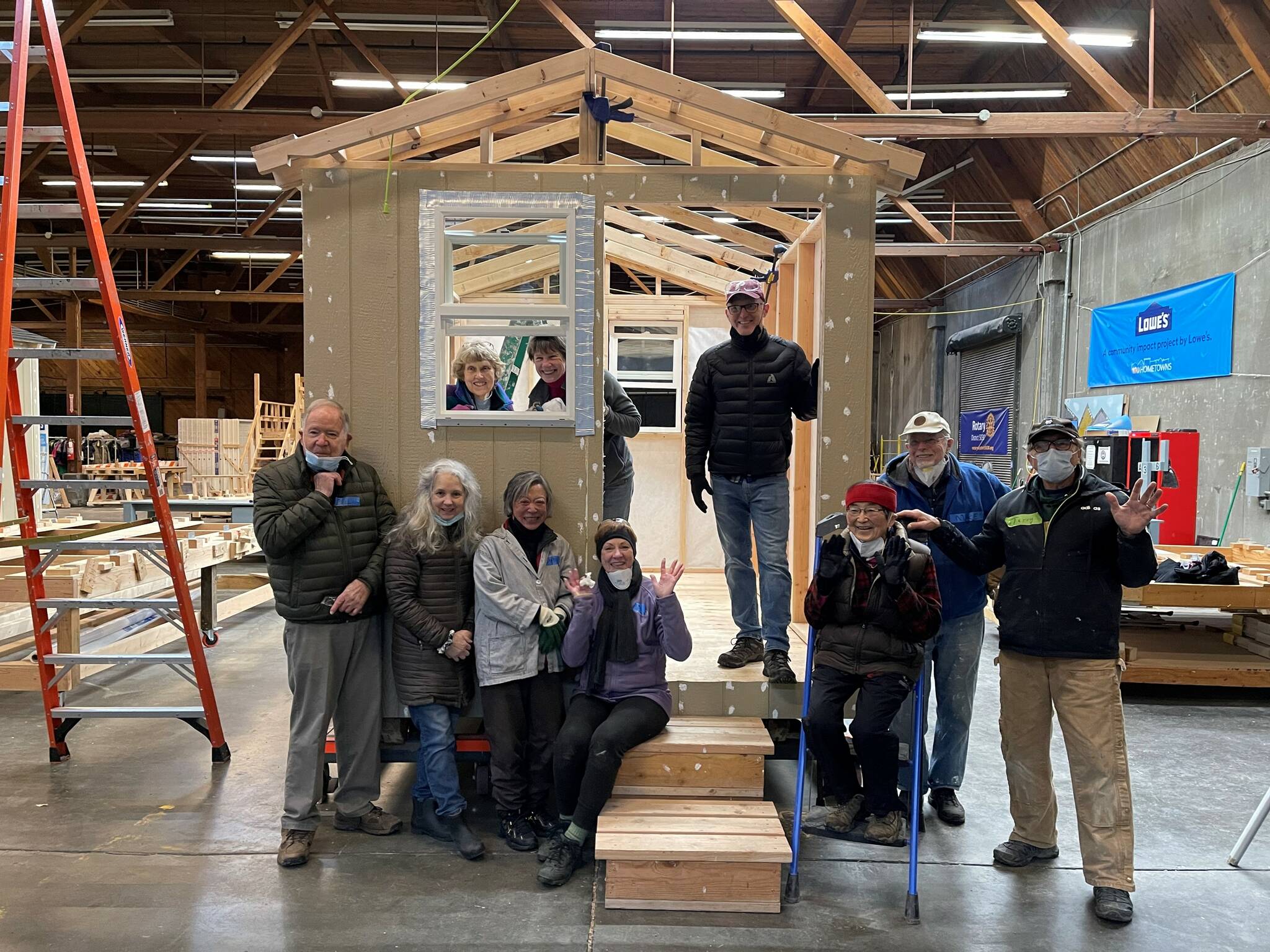 On Jan. 3, four Mercer Island Rotarians were part of a group that helped build a tiny home in coordination with Sound Foundations NW at the Hope Factory in Seattle. Sound Foundations NW, which partners with the Low Income Housing Institute to construct the abodes, states on its website: “Imagine what it would be like during the pandemic not to have a home. Nowhere safe and secure to keep you from the virus. That’s why we have been deemed an essential organization and are building transitional tiny homes as fast as we can. The homes are for healthy homeless folks to stay healthy and away from the virus.” Pictured Rotarians are Bunnie Cundiff (sitting on stairs); Edie Warner (in window to the right); Mike Finn (standing, second from right); and Terry Lee (farthest right). For more information, visit https://www.soundfoundationsnw.org/ . Courtesy photo