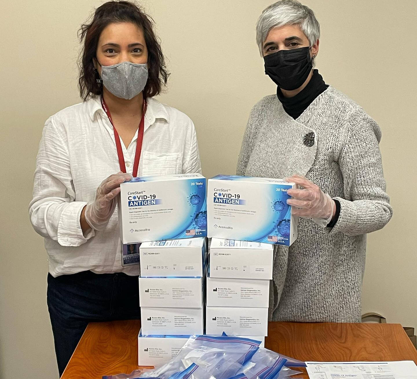 On Jan. 10 at the Mercer Island School District (MISD) office, Sophia Murrey (left) and Nuria Lencia (right) prepared COVID-19 testing packets for families. MISD staff handed out packets on the morning of Jan. 11 for students eligible to return to school on an earlier timeline in accordance with the Washington State Department of Health’s recent update via the Centers for Disease Control and Prevention’s recommendations. “MISD is attempting to roll out the shortened quarantine timelines as quickly as possible for all students,” reads the district’s Facebook page. Photo courtesy of the Mercer Island School District