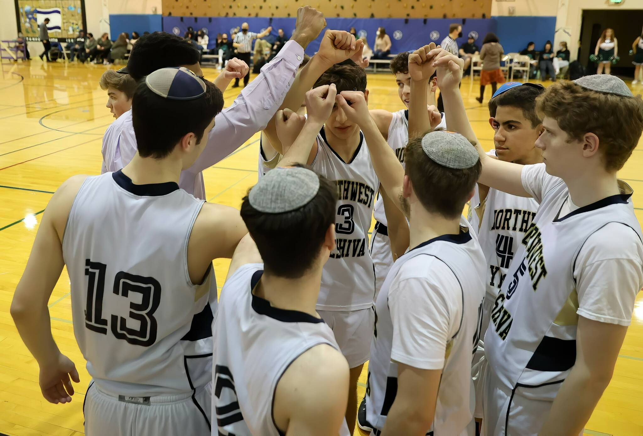 The Northwest Yeshiva High School boys varsity basketball team prepares to break from a huddle. Photo courtesy of David Jacoby