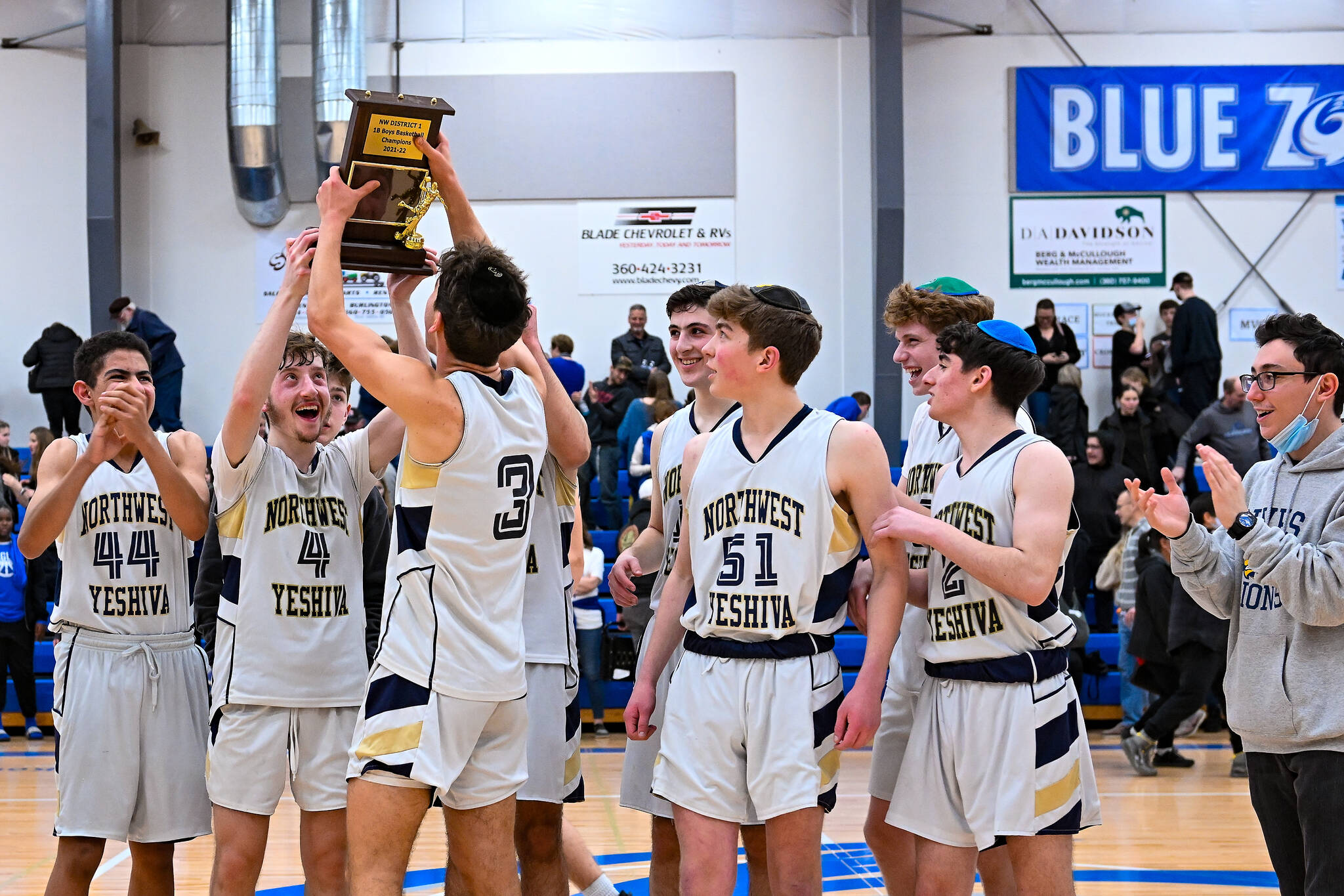 Northwest Yeshiva High School boys basketball players celebrate winning the Northwest District 1 1B championship over Mount Vernon Christian, 57-46, on Feb. 19. The Mercer Island squad (15-3-1 overall) qualifies for state and will tip off in the first round against Naselle at 9 a.m. March 2 at Spokane Arena. At regionals, Moses Lake Christian Academy/Covenant Christian School defeated the locals, 61-60, on Feb. 26 at Bellevue College for state seeding. Lion senior Yoel Kintzer was named the Sea-Tac B League most valuable player, senior Dovi Goldberg is a first-teamer and senior Victor Maimon is an honorable mention. Photo courtesy of Patrick Krohn