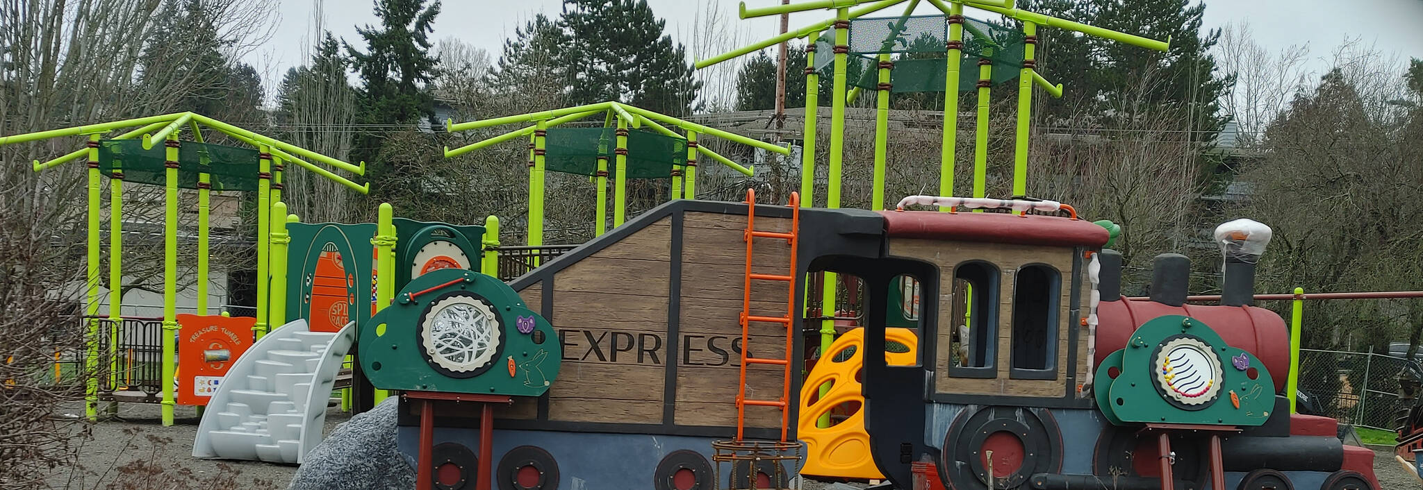 The Mercerdale Park playground train play sculpture and other play equipment sit behind fences until the reopening. Andy Nystrom/ staff photo