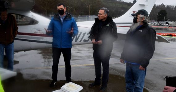 County Executive Dow Constantine (center) speaks outside of a plane that landed at King County Airport March 2, carrying 12,000 kokanee salmon eggs, with Kokanee Work Group Recovery Program Manager Perry Falcone (L) and Snoqualmie Tribal Councilmember Bill Sweet. Photo Conor Wilson/Valley Record.