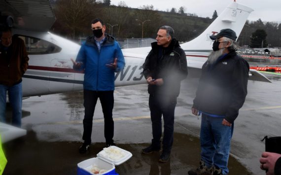 County Executive Dow Constantine (center) speaks outside of a plane that landed at King County Airport March 2, carrying 12,000 kokanee salmon eggs, with Kokanee Work Group Recovery Program Manager Perry Falcone (L) and Snoqualmie Tribal Councilmember Bill Sweet. Photo Conor Wilson/Valley Record.