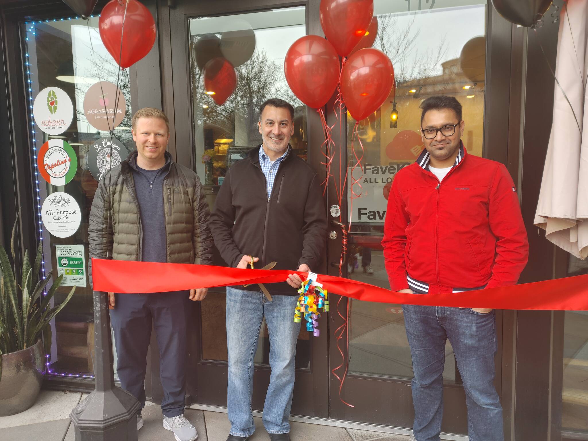 From left, Mercer Island Deputy Mayor David Rosenbaum, Mayor Salim Nice and FaveKitchens founder/CEO Praveen Akula gather at the restaurant’s grand opening on March 11. Andy Nystrom/ staff photo