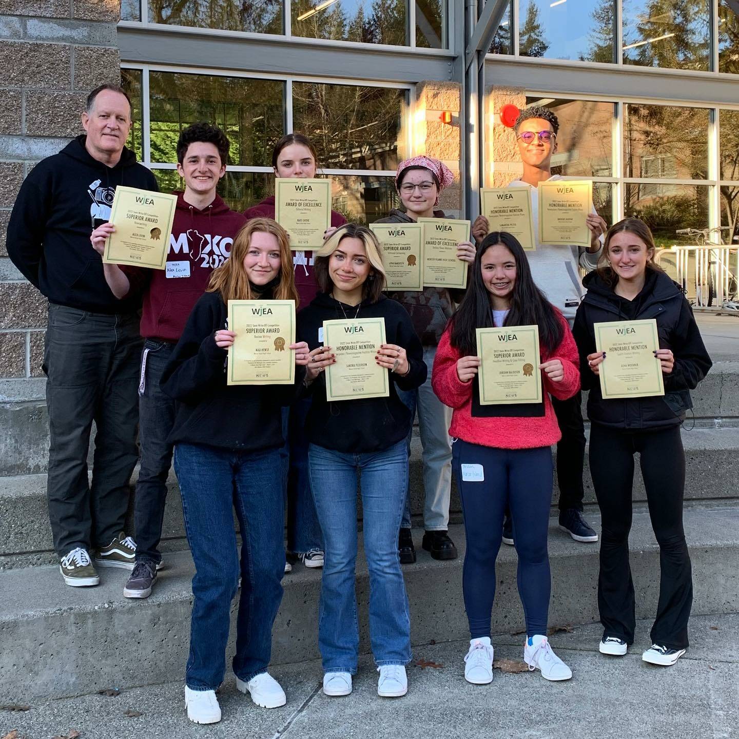 A host of Mercer Island High School (MIHS) journalists garnered awards at the Washington Journalism Education Association 2022 spring conference on March 5 at MIHS. Pictured are top row, left to right: Chris Twombley (English and journalism teacher), Alex Levin (Superior: Newswriting, State Journalist of the Year), Kate Grove (Excellent: Editorial Writing), Lena Hardisty (Superior: Editorial Cartooning) and Brooks Kahsai (Honorable Mention: Sports Action Photography). Bottom row, left to right: Max Hense (Superior: Review Writing), Sandra Pederson (Honorable Mention: Newspaper Feature Writing), Jordan Balousek (Superior: Headline Writing and Copy Editing) and Honor Warburg. Not pictured: Asha Woerner (Honorable Mention: Sports Feature Writing), Sam Pelter (Honorable Mention: Newspaper Feature Photo), Piper Pokorny (Excellent: Yearbook Sports Photo) and Mischa Gregory (Honorable Mention: Yearbook Feature Photo). MIHS also received, Excellent: News Website. Photo courtesy of the Mercer Island School District