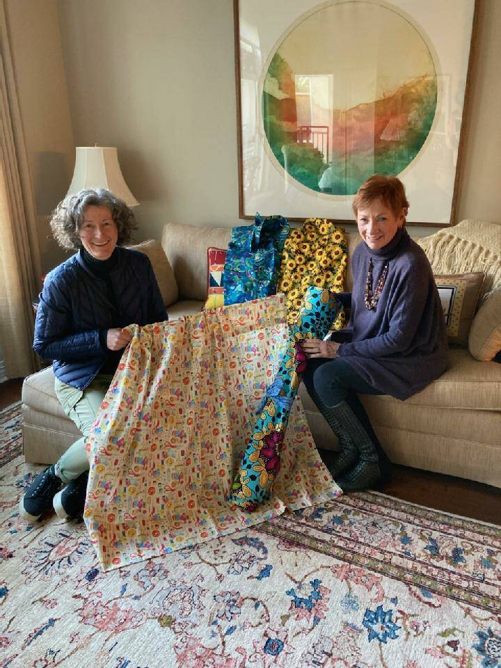 Bonnie Cundiff, right, and her daughter-in-law Kelly Cundiff check out curtains people have made and contributed to be placed in tiny homes. Courtesy photo