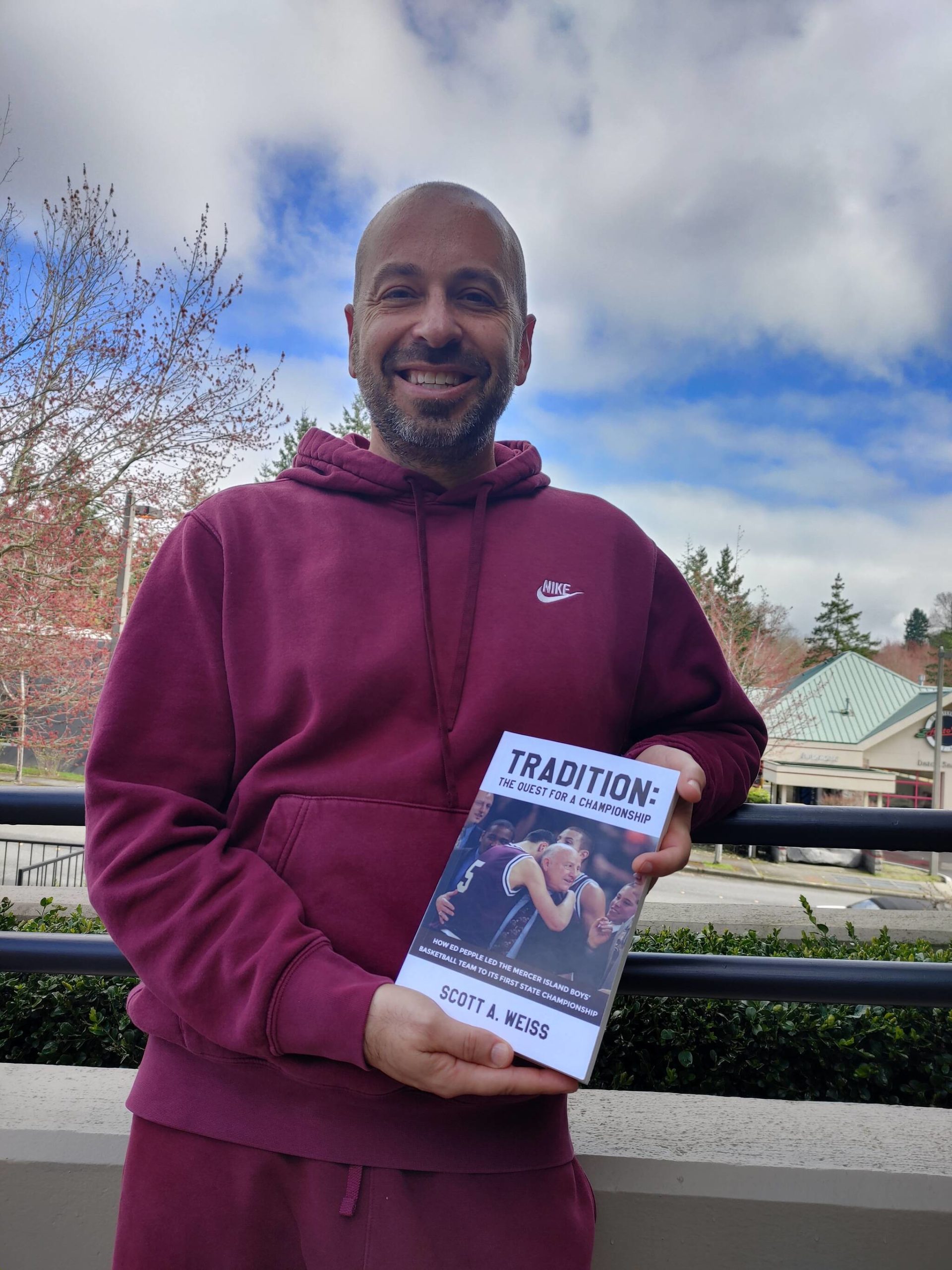 Mercer Island resident Scott A. Weiss displays his new book about legendary Islander boys basketball head coach Ed Pepple. Andy Nystrom/ staff photo