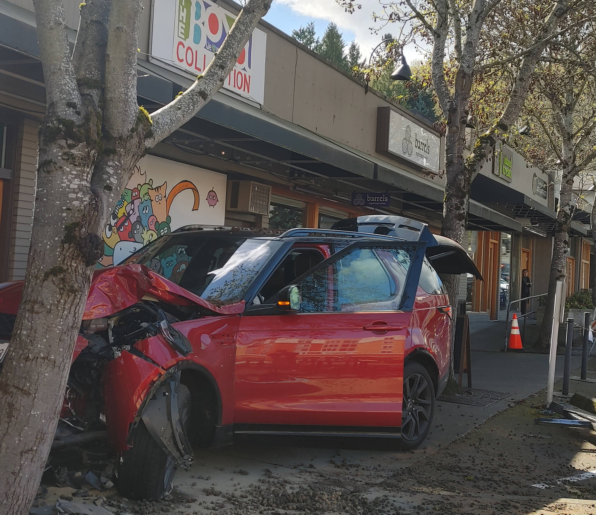 On the afternoon of April 5, a driver attempting to park in a space in The Boyd Collection lot surged forward and crashed his red SUV into a tree on the sidewalk, according to witnesses. Police, fire and emergency vehicles were on the scene after receiving a call at about 2:20 p.m. and the driver received a precautionary transport to the hospital with a possible injury, according to police and witness reports. There was no damage to any of the shops. The Boyd Collection is located at 7605 SE 27th St. Andy Nystrom/ staff photo