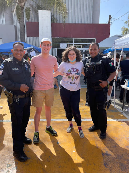 Mercer Island High School juniors Simona Yaroslavsky and Matthew Smith visit with policemen at the Mexico-United States border near San Diego. Courtesy of Rouslana Yaroslavsky