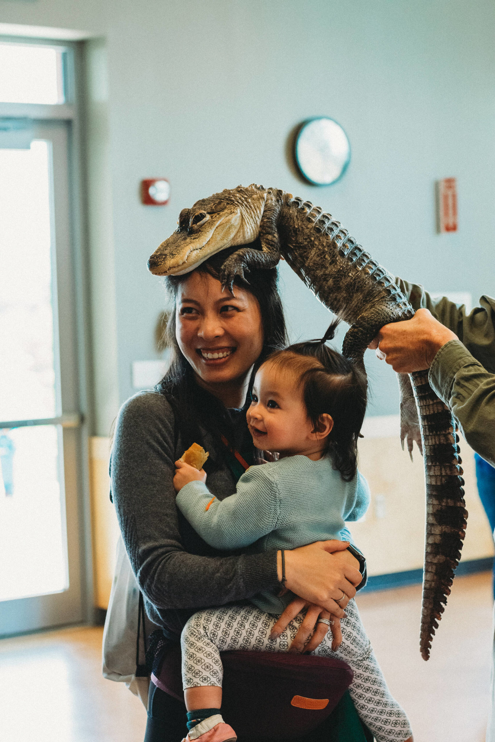 Fan Yaun and her daughter Rya, 1, visit with an alligator that The Reptile Man brought to last Saturday’s Circus event at the Mercer Island Community and Event Center. The Mercer Island Preschool Association and the city presented the all-ages event, which also featured a police boat, carnival games, a petting zoo, face painting and more. Courtesy of B3 photography
