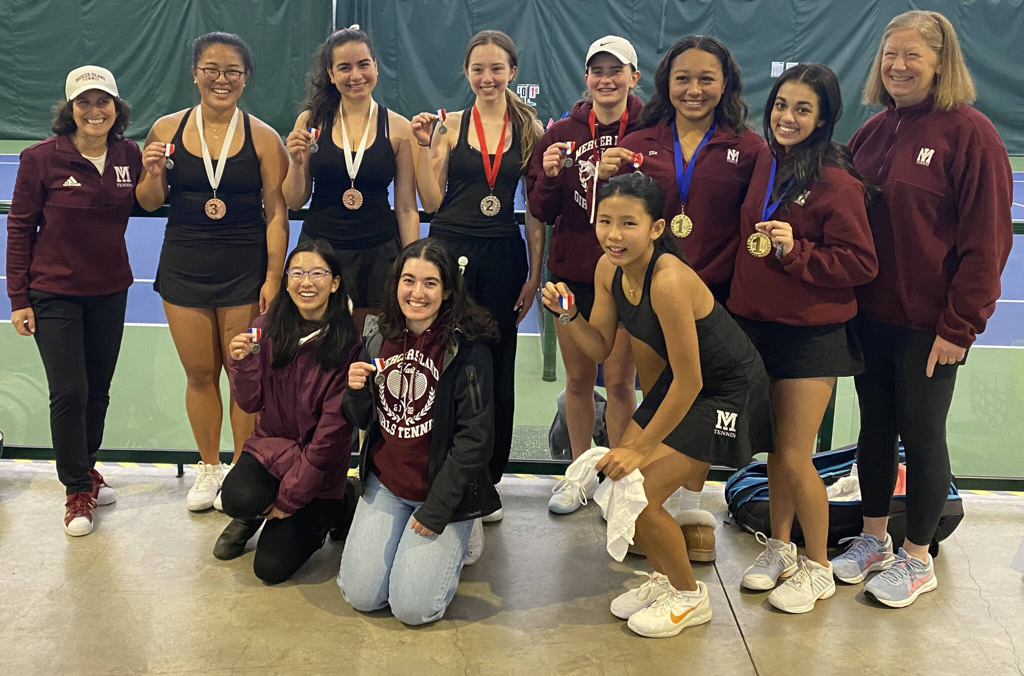 The Mercer Island High School girls tennis squad recently won the 3A KingCo tournament title and advanced to districts. Top row, left to right: Coach Carol Gullstad, third-place KingCo doubles partners Izzy Roe and Mira Patel, second-place KingCo doubles partners Ava Chatalas and Rachel Garton, first-place KingCo doubles partners Ella Simpson and Jaya Manhas and coach Julie Stillman. Bottom row, left to right: Maya Wong, Sanan Karami and fourth-place KingCo singles player Chloe DeGracia. The doubles teams of Simpson-Manhas (No. 1) and Garton-Chatalas (No. 2), and singles player DeGracia (No. 6) advanced to state. The Roe-Patel doubles squad (No. 7) is a state alternate. Photo courtesy of Niraj Patel
