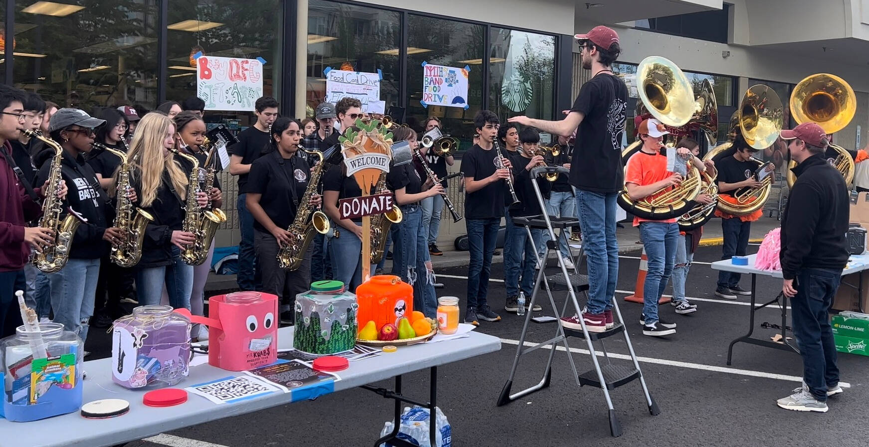 The Mercer Island High School band collected just under $7,000 on May 14 for the Mercer Island Youth and Family Services Food Assistance Program by performing and taking donations at the north- and south-end QFCs. Courtesy photo