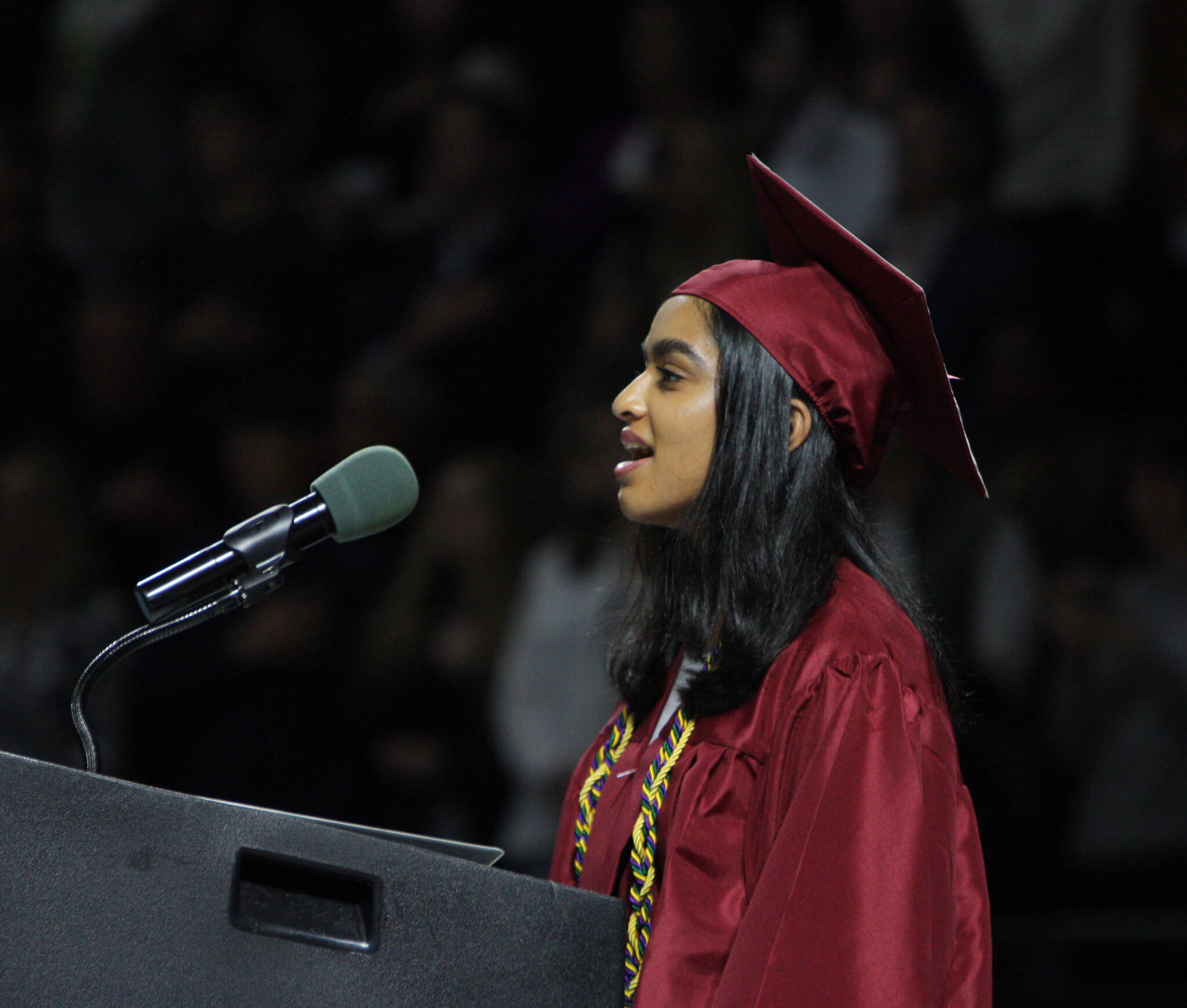 Graduate Nandini Rathod sings the National Anthem. Andy Nystrom/ staff photo