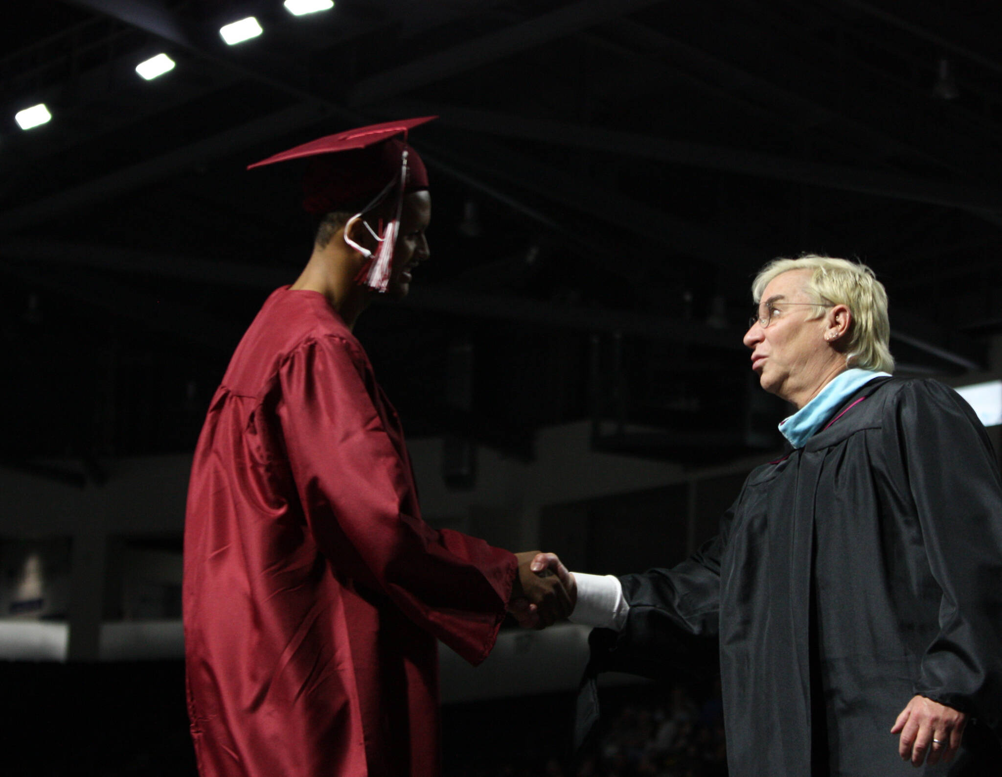 Principal Walter Kelly congratulates graduate Luke Reid. Andy Nystrom/ staff photo