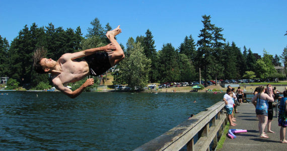 Fedor Osipov, 15, flips into Steel Lake in Federal Way during last year's heatwave on June 28, 2021. Olivia Sullivan/Sound Publishing