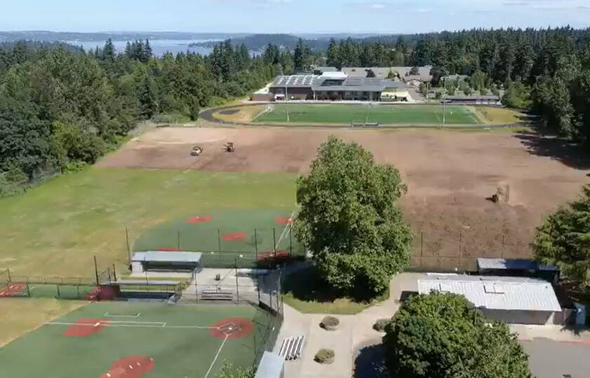 This summer, a construction crew is converting South Mercer Playfields to synthetic turf and lining them for soccer, lacrosse and football. The area will feature a small secondary playfield. The large ballfield will be LED lit, and one softball diamond will be fully turfed and LED lit and include new dugouts. The project is estimated to be completed by December/January. Screenshot from Mercer Island School District video