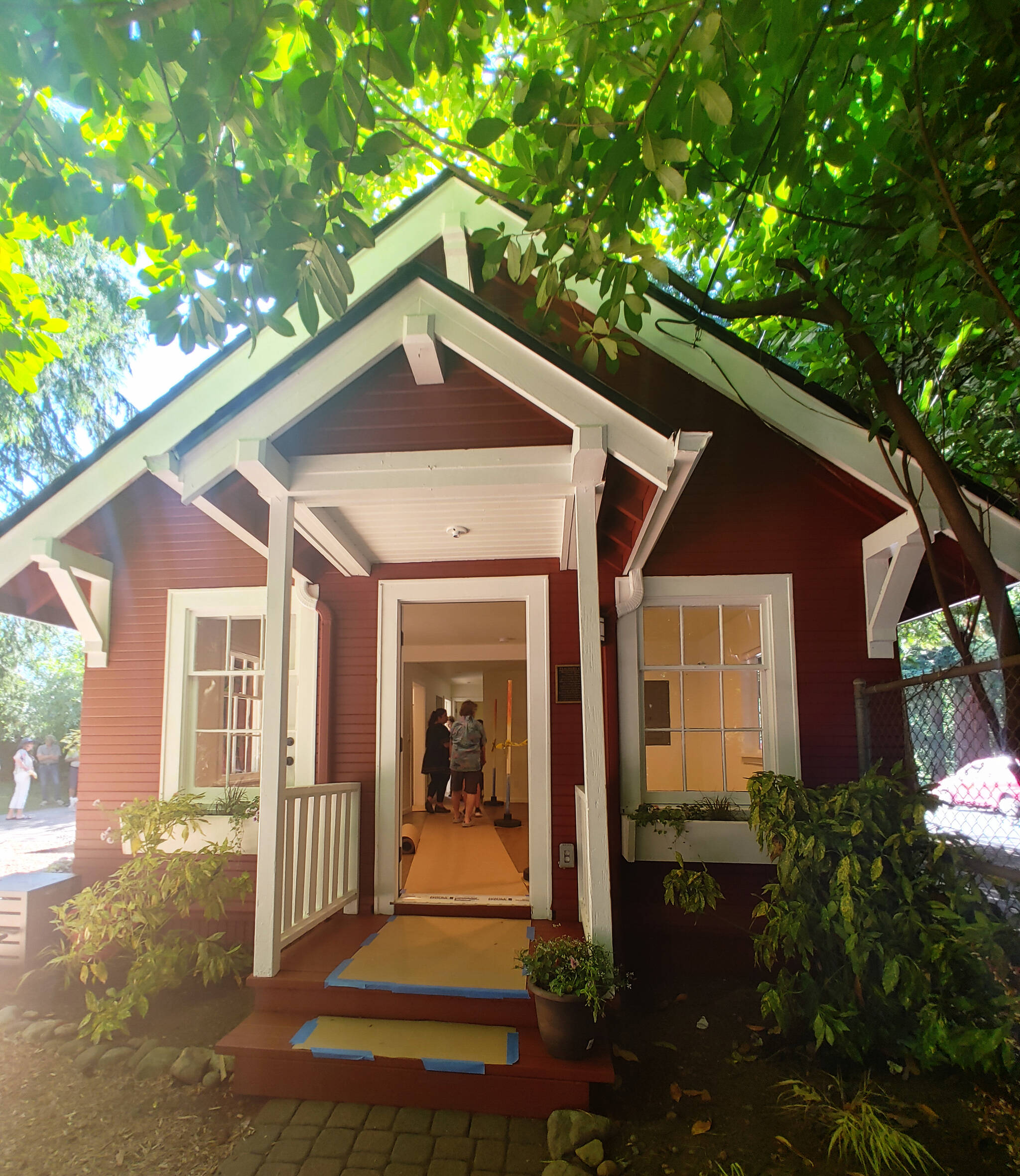 On the afternoon of July 20, people tour the restored Lakeview Schoolhouse teacher’s cottage, which was built on the school grounds in 1918 and caught fire in 2018. Andy Nystrom/ staff photo