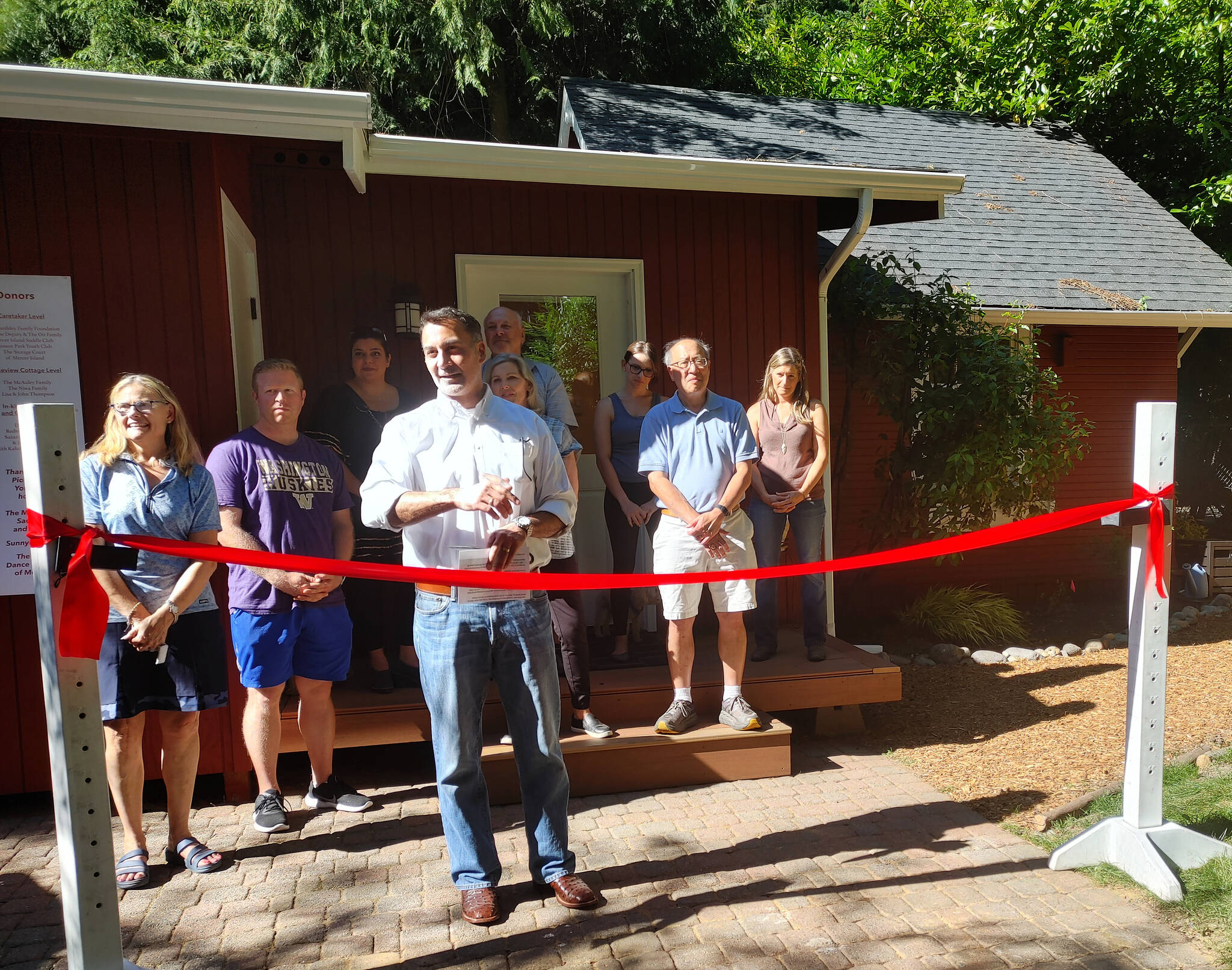 Restored Lakeview Schoolhouse teacher’s cottage ribbon cutting on July 20: From left to right, Caroline Bombar-Kaplan, Deputy Mayor David Rosenbaum, Suzanne Zahr, Mayor Salim Nice, Gary Redman, Lisa Thompson, Faith Kalucki, former mayor Benson Wong and Jennifer Brenes. Andy Nystrom/ staff photo