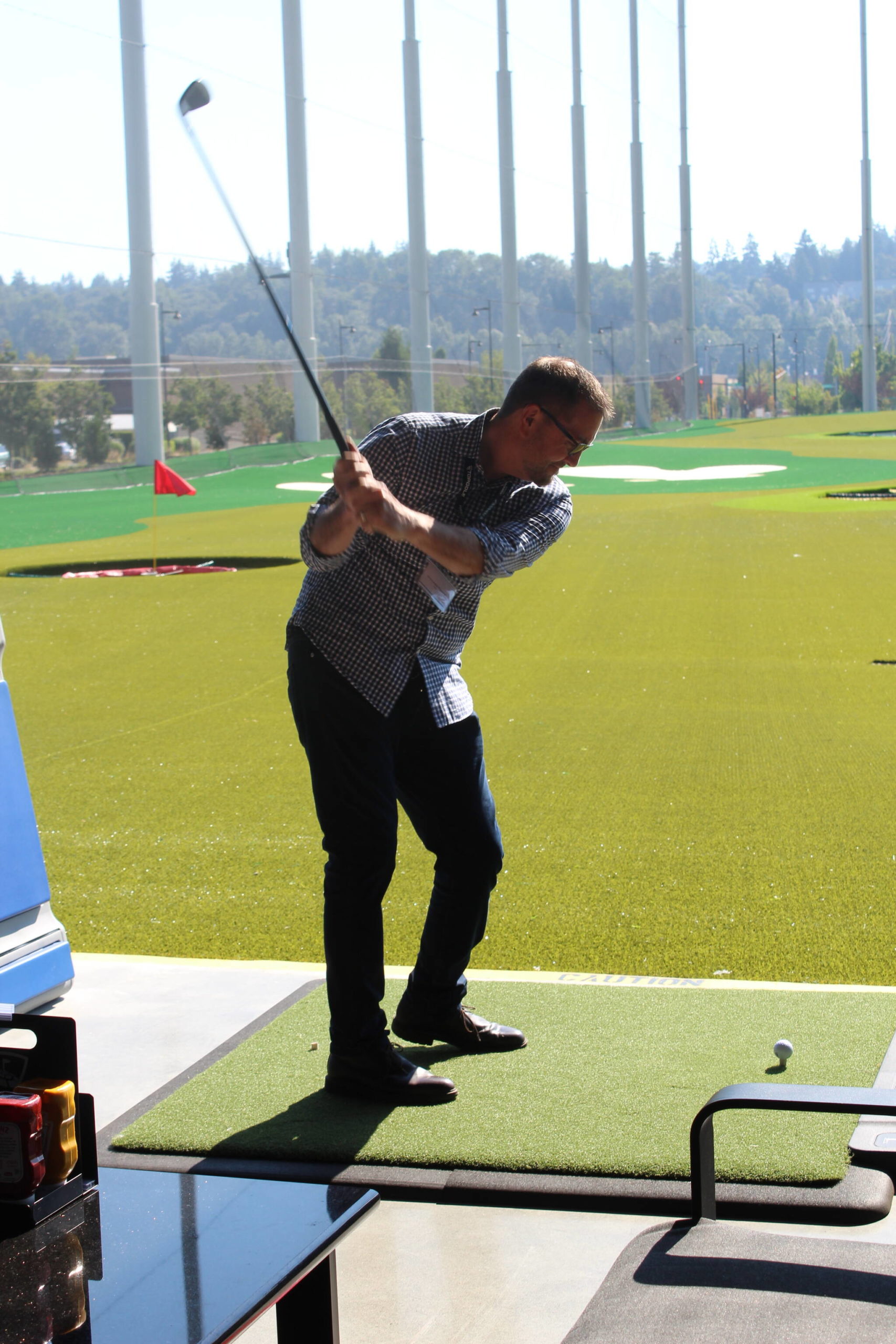 Renton Mayor Armondo Pavone takes a swing on opening day at Topgolf Renton. Photo by Bailey Jo Josie/Sound Publishing