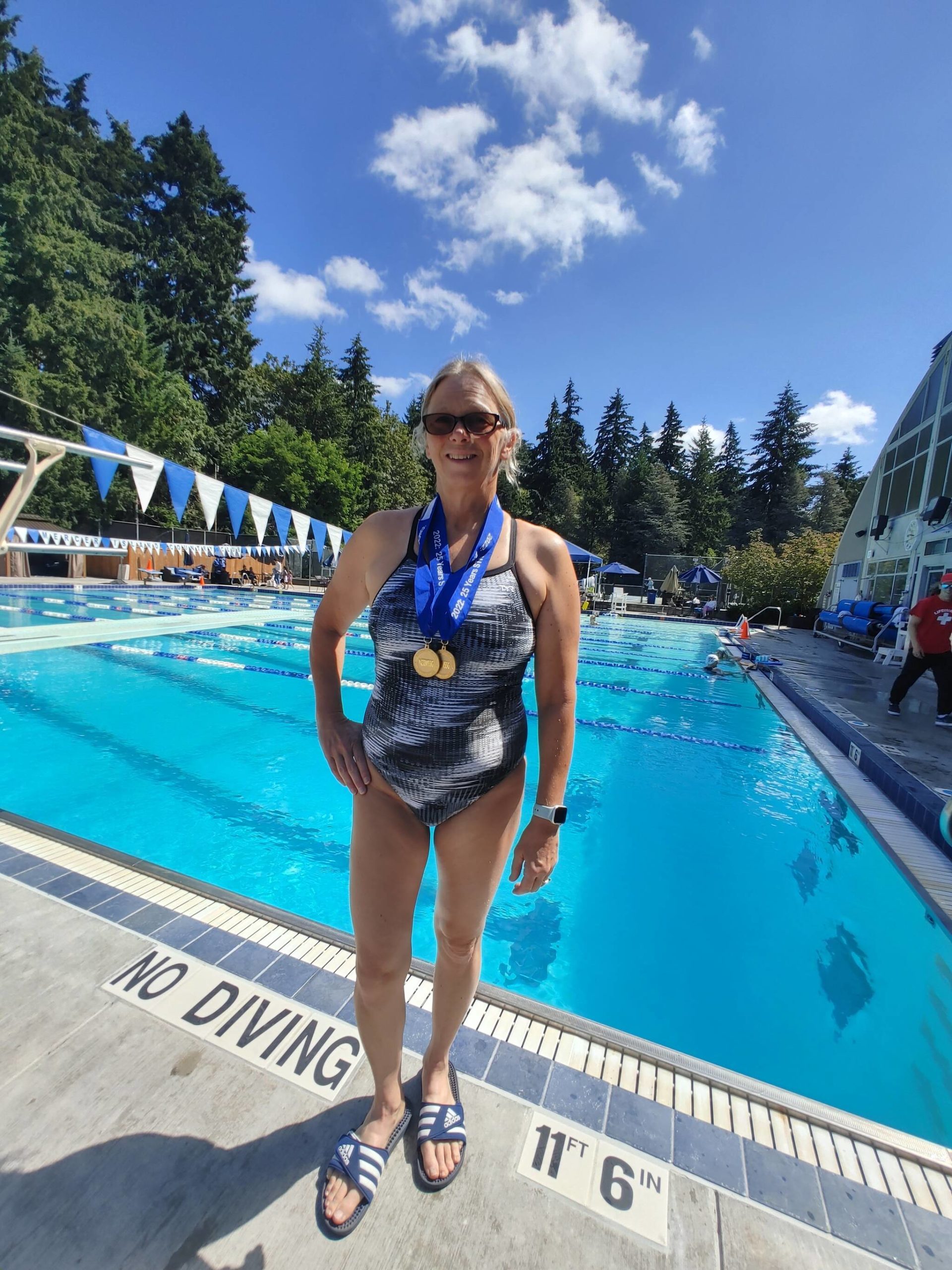 Wendy Hoffman displays two of her four gold medals from the Washington State Senior Games on a recent morning at the Mercer Island Country Club. Andy Nystrom/ staff photo