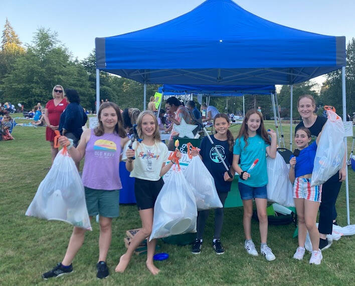 Mercer Island’s Girl Scout Cadette Troop 46755 picked up trash at the Mostly Music in the Park event on Aug. 11 as the culminating project for its Girl Scout Bronze Award. Deputy Mayor David Rosenbaum joined the troop at Mercerdale Park for its “Slam Dunk the Junk” event. The troop’s poster at its booth read, in part: “Help us pick up the trash. If everyone pitches in and does their part, the environment can be clean! So go spread the word and pick up trash!” Pictured from left to right: Juliette Lowe, Ragen Whelan, Caydence Powell, Evelyn Quekett, Madeline Silbey and leader Christina Quekett. Not pictured: leader Rochelle Whelan. Photo courtesy of Shelley Whelan