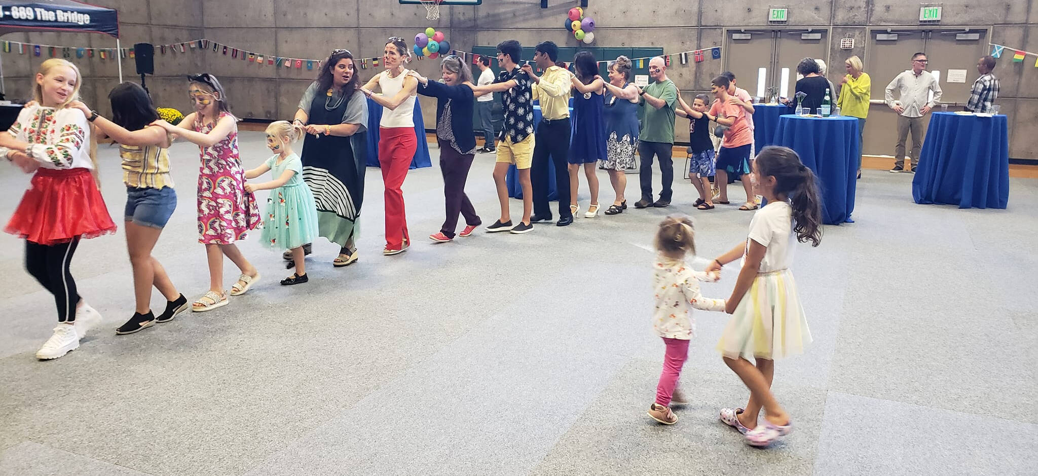 Attendees at the Rotary Club of Mercer Island’s International Dance for Peace form a spontaneous conga line while children dance to live world music on Sept. 18 at the Mercer Island Community and Event Center. The event, which drew about 300 people and was billed as an “All Island Dance Party,” raised a significant amount of money to support international grants and humanitarian aid, including ones for Ukraine. Multiple Ukrainians who live on Mercer Island attended the event and met each other. The event replaced the Rotary half marathon, which had to be canceled due to COVID, and featured world music, a homemade-cookie table, a Drum Roll wine bar and multigenerational attendees from children to grandparents. The amount raised was not available at press time. To donate, visit <a href="http://www.mirotarydance.org" target="_blank">www.</a><a href="http://www.mirotarydance.org" target="_blank">mirotarydance.org</a>. Photo courtesy of John Hamer