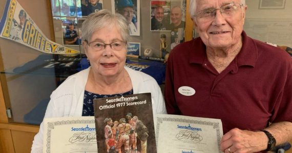 Denny and Sharon Horn, Mercer Island residents, hold certificates and an official program from the Seattle Mariners’ first home game in 1977, played in the Kingdome. The Horns are among the growing crowd of fan hopefuls cheering the Mariners chances of making postseason play. They watched with pride as Mercer Islander Matt Boyd get his first win as a Mariners pitcher last week. The Horn family and Boyd family are longtime members of Evergreen Covenant Church on the island. Courtesy photo