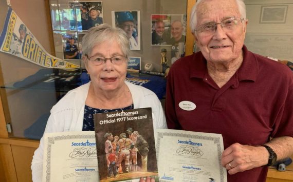 Denny and Sharon Horn, Mercer Island residents, hold certificates and an official program from the Seattle Mariners’ first home game in 1977, played in the Kingdome. The Horns are among the growing crowd of fan hopefuls cheering the Mariners chances of making postseason play. They watched with pride as Mercer Islander Matt Boyd get his first win as a Mariners pitcher last week. The Horn family and Boyd family are longtime members of Evergreen Covenant Church on the island. Courtesy photo