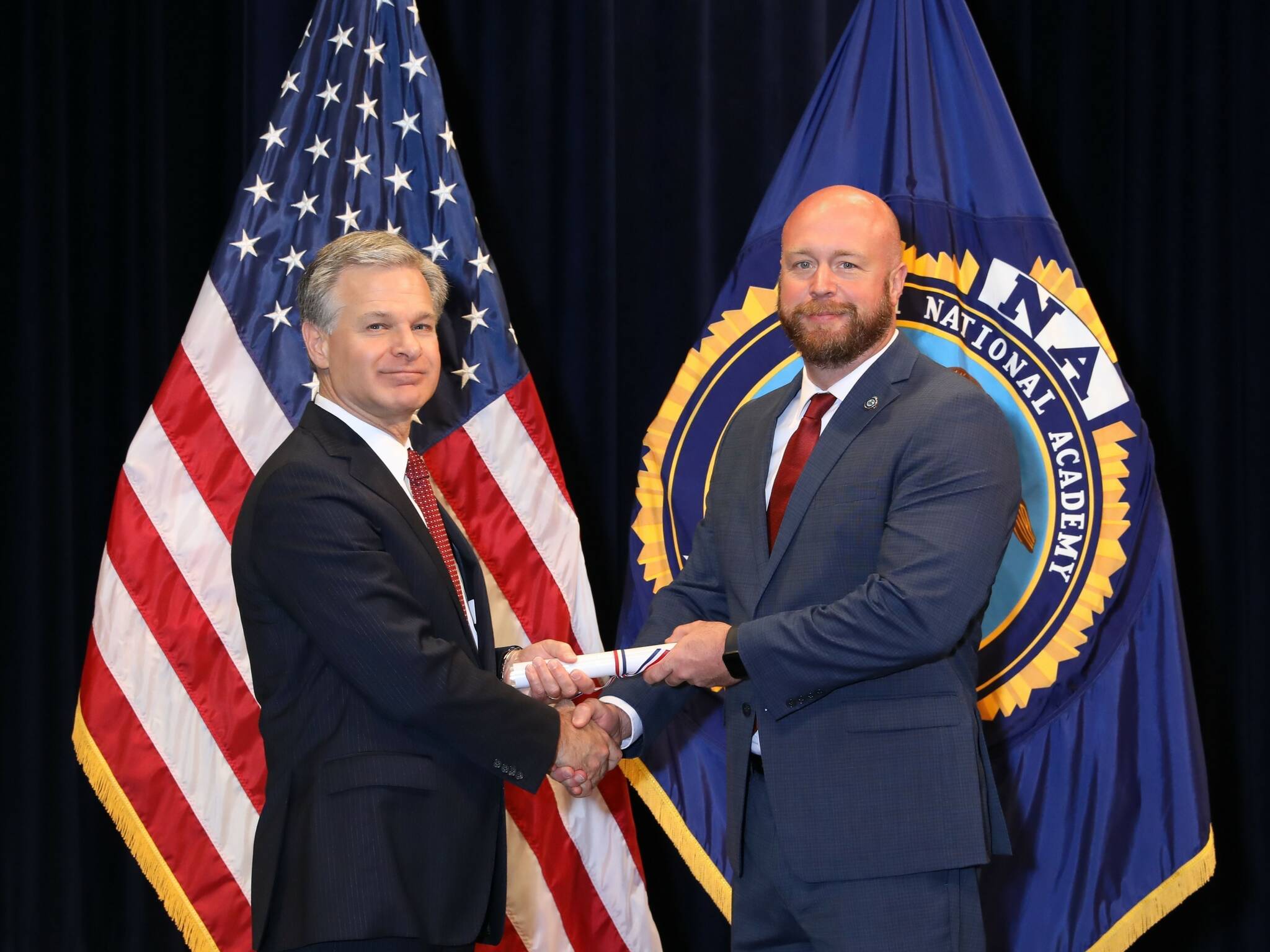 From left, FBI Director Christopher Wray presents Mercer Island Police Department Operations Commander Mike Seifert with his diploma after graduating from the FBI National Academy in Quantico, Virginia, last month. Photo courtesy of the Mercer Island Police Department