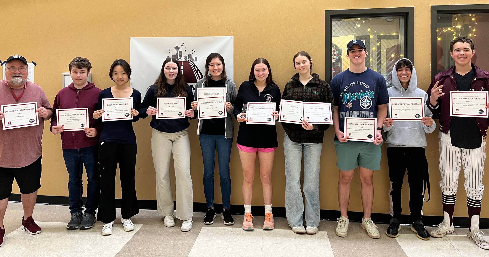 From left to right, KMIH 889 The Bridge general manager and broadcast teacher Joe Bryant along with student broadcasters Theodore Freeman, Grace Go, Annabelle Hegarty, Sophia Azzano, Sophie Prock, Sophie Cartwright, Dylan Shobe, Noah Perlman and Gill MacDonald. Courtesy photo