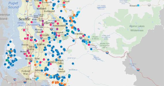 A map of various Land Conservation Initiative projects in King County. Dark blue spots represent natural lands; light blue, rivers; green, forests; pink, urban green space; purple, regional trails; and yellow, farmland. Map courtesy King County