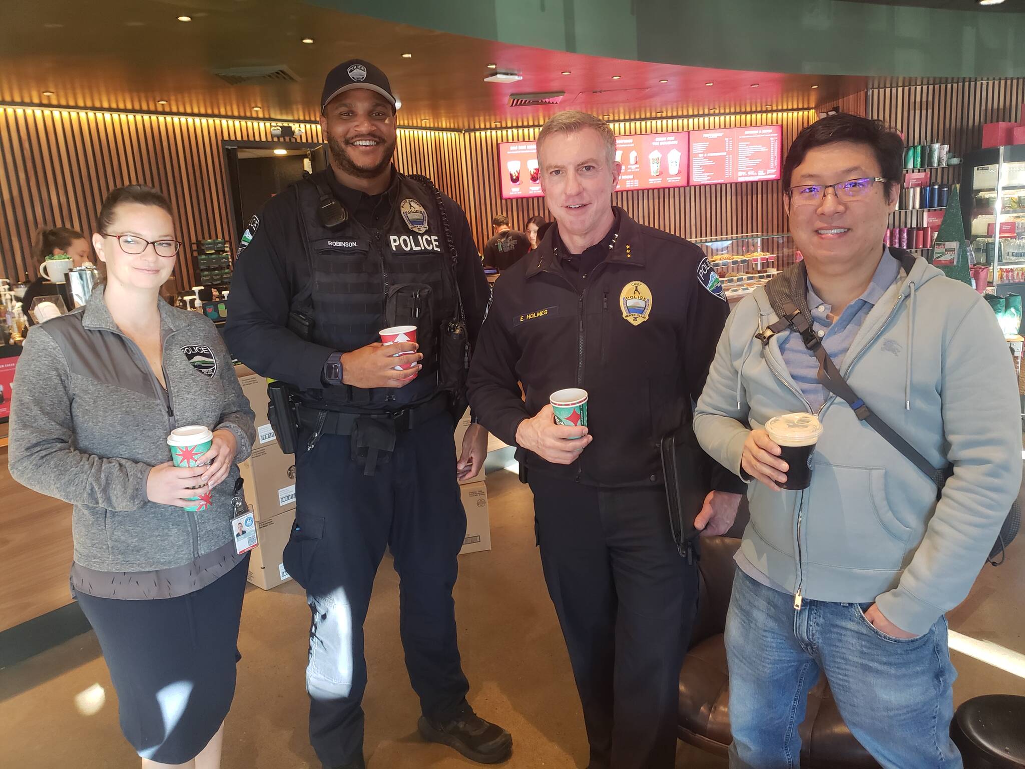 Courtesy photo
From left to right: MIPD’s Lindsey Tusing, Kelly Robinson, Chief Ed Holmes, and MI resident James Han.