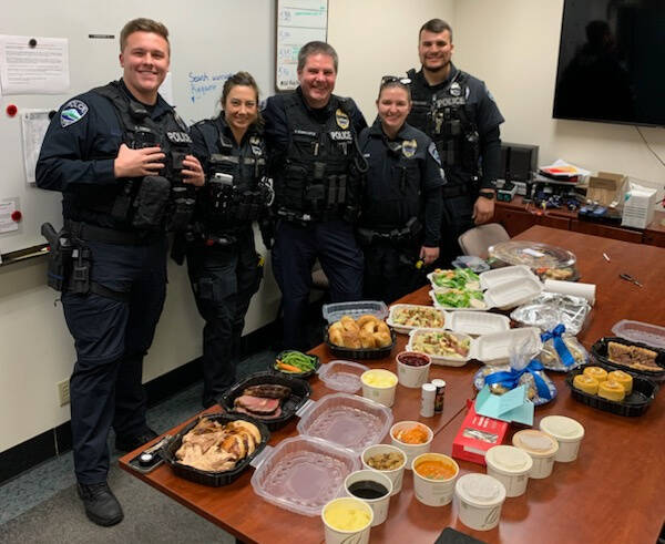 The MI Back the Blue community group provided a Thanksgiving dinner to show its appreciation for the Mercer Island Police Department, featuring, from left, August Owen, Kristina Lum, Sgt. George Schmalhofer, Cpl. Samantha Hammer and Nick Palandri. “On behalf of the officers who spent their Thanksgiving holiday at work, I want to express my sincere thanks for your exceptional generosity in providing them with a wonderful Thanksgiving day dinner,” said Chief Ed Holmes in a letter to the group. “Working in a community that supports their police department means so much to all of us. You all play a significant role in making this a great place to work as a police officer.” The group members are: Carv Zwingle, Susan Lund, Gary Robinson, Fay Wang, Laura and Mae Brado, Corinna Sager, Terry Wong and Christina Hogue. Courtesy photo