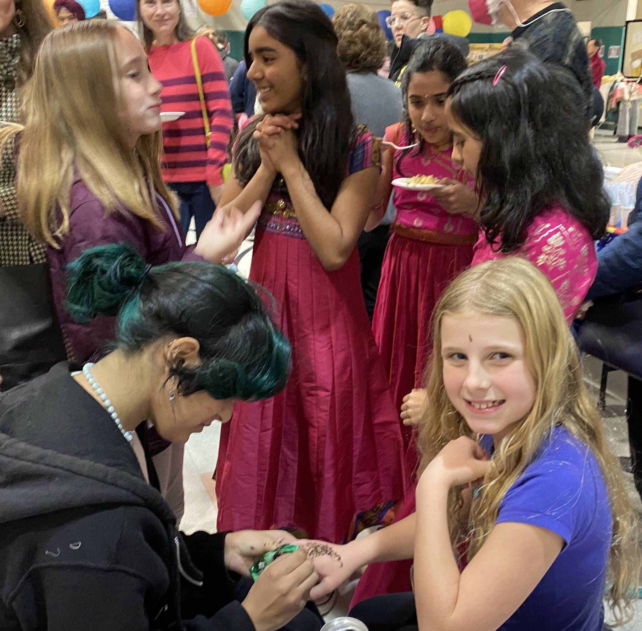 Students enjoy the event, which included a visit with a mehndi/henna artist. (Photos courtesy of Soyun Chow)