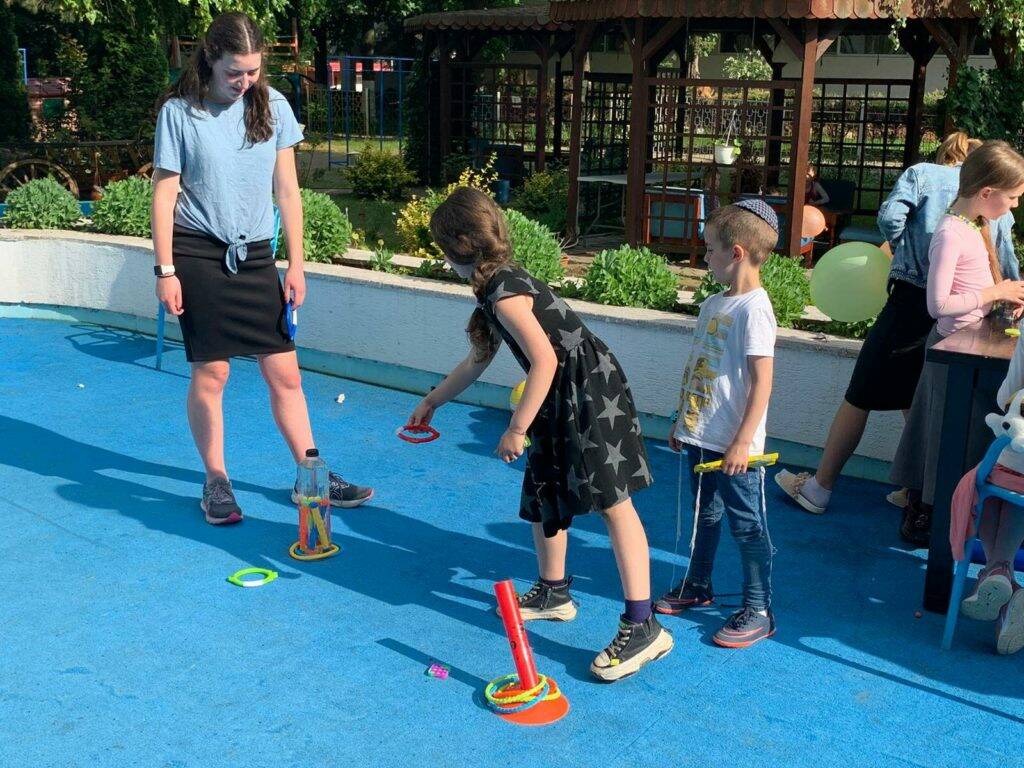 Northwest Yeshiva High School senior and Mercer Island resident Simone Sandorffy plays ring toss with Ukrainian orphans during a carnival in Neptun, Romania. Courtesy photo