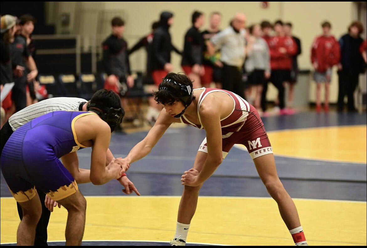 Mercer Island High School’s Chase Warnick, right, prepares to battle an opponent on the wrestling mat this season. Photo courtesy of Aaron Koopman