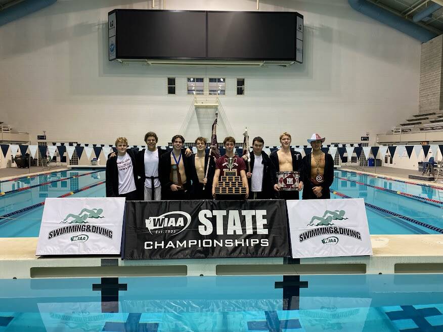 Mercer Island High School seniors, from left to right, David Garton, Jamie Feinstein, Coy Hounsell, Emmett Ralston, Nolan Knievel, Matthew Shield, Matt Williamson and Evan Liu celebrate their team’s 3A state swim and dive championship on Feb. 18 at the King County Aquatic Center in Federal Way. Photo courtesy of Lexi Liu