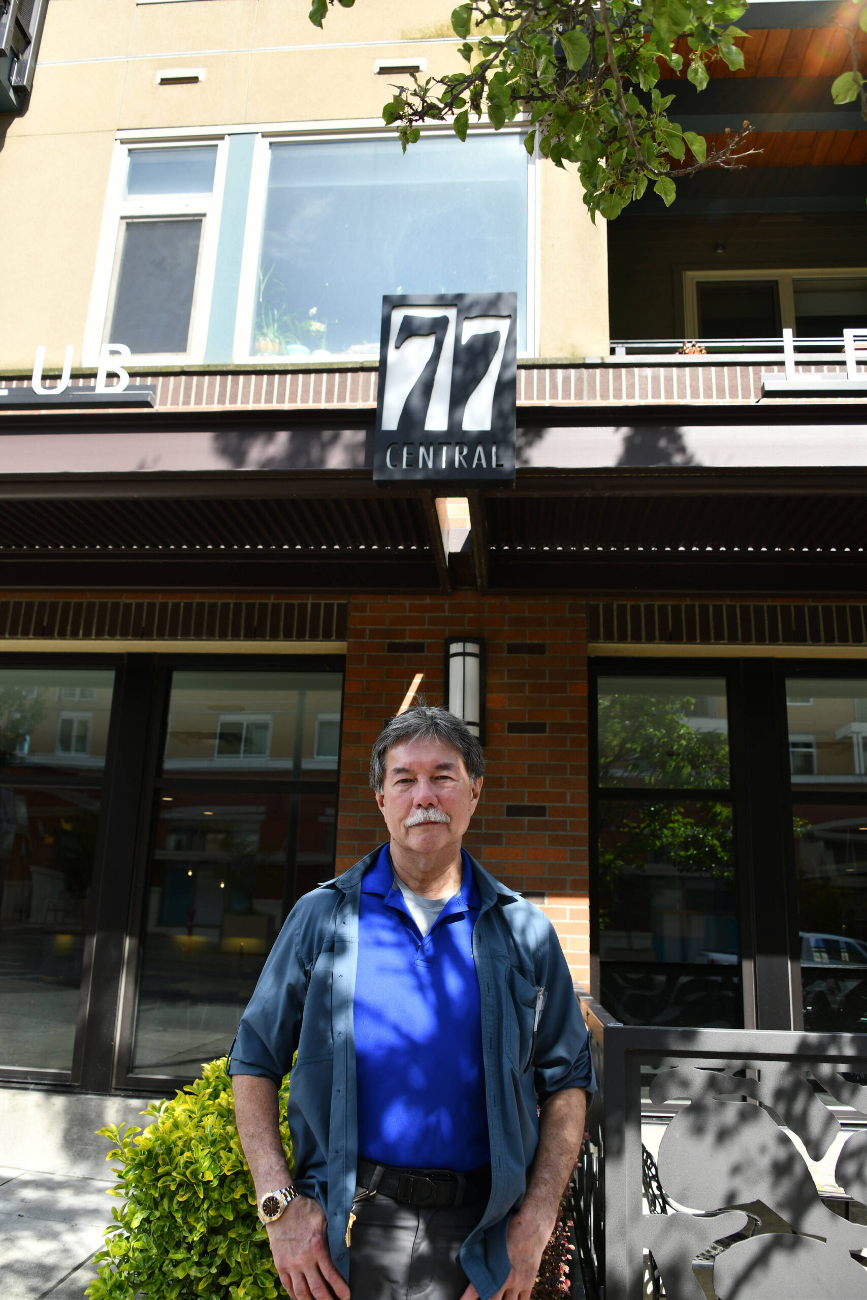 Former 77 Central resident Bob Gilbert stands in front of the Mercer Island building on the afternoon of May 9. Andy Nystrom/ staff photo