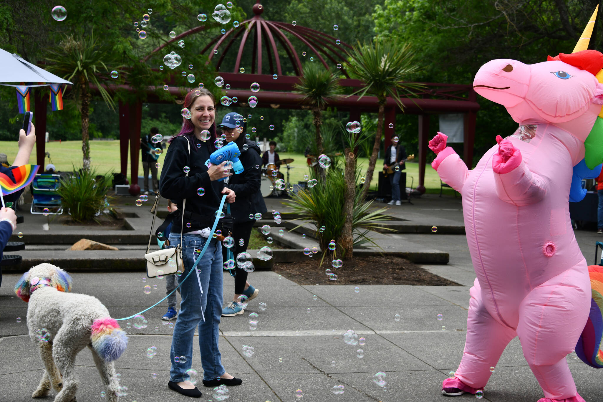 Litza Griffin-Johnson unleashes bubbles while a unicorn dances to live music at the Mercer Island Pride in the Park Celebration on June 17 at Mercerdale Park. Andy Nystrom/ staff photo