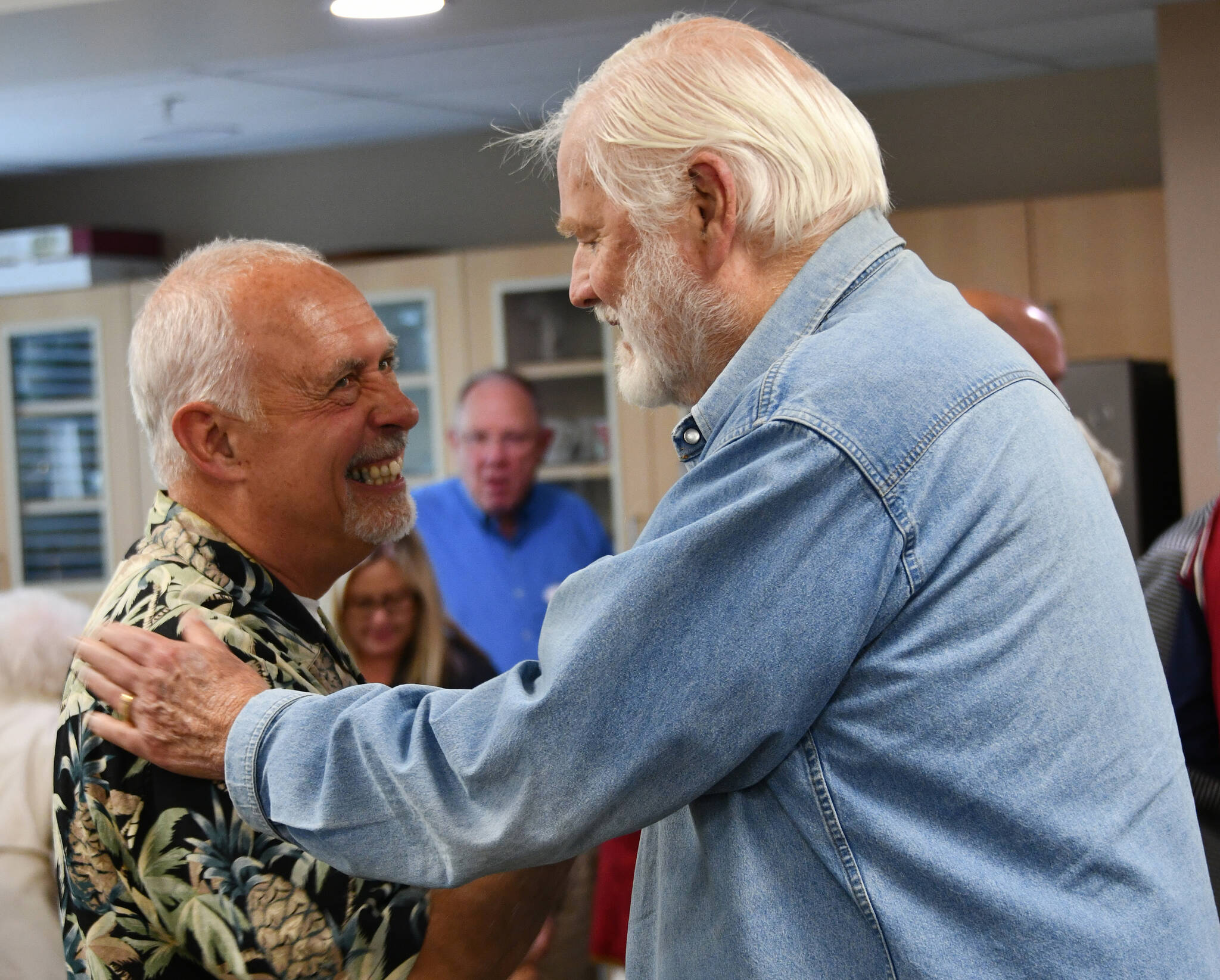 Chaplain Greg Asimakoupoulos, left, chats with Dick Sundholm at the chaplain’s retirement celebration on June 21 at Covenant Living at the Shores on Mercer Island. Andy Nystrom/ staff photo