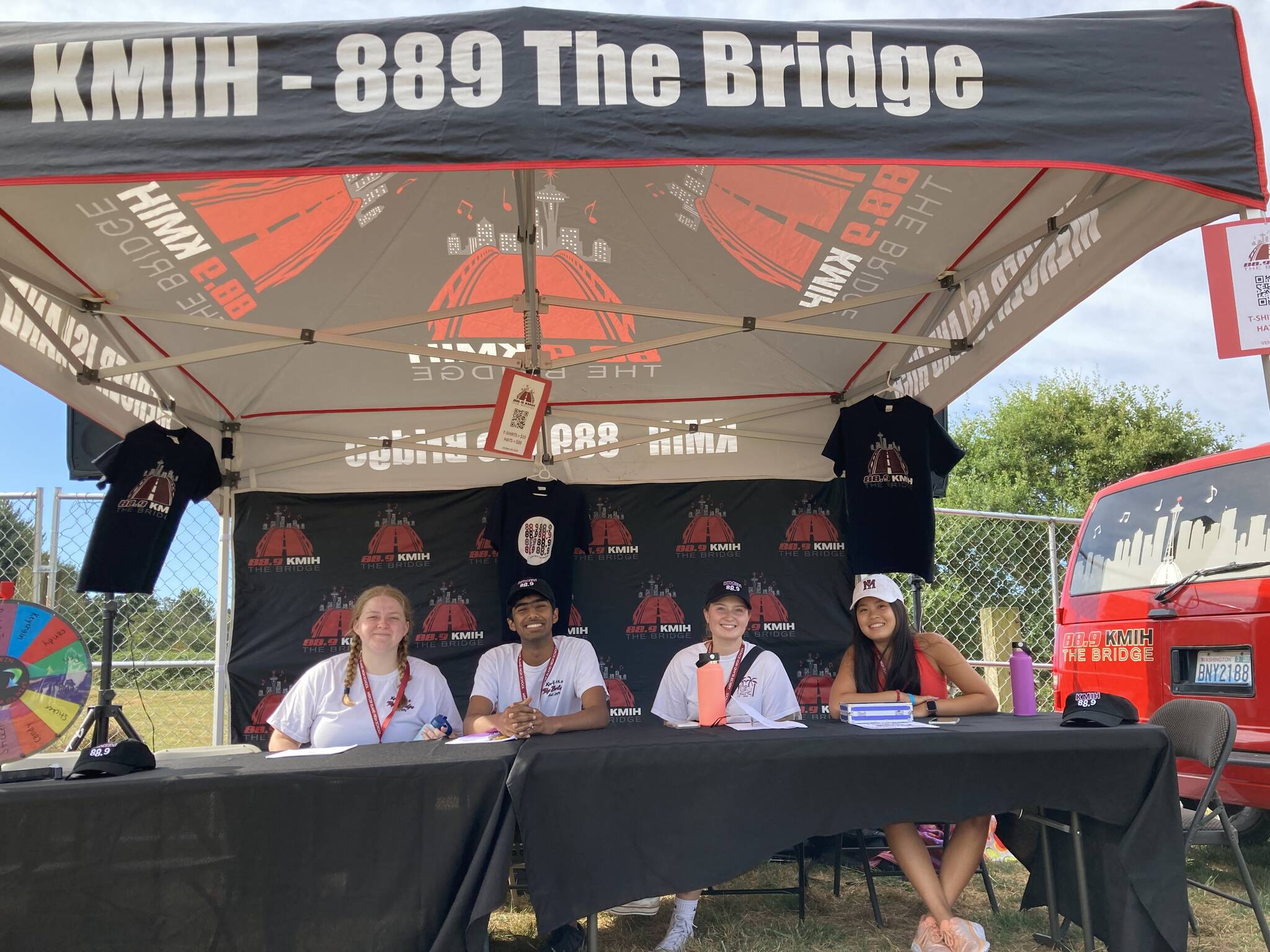 Left to right, Mercer Island High School rising senior Ellie Sadlier, rising senior Sidh Shroff, 2023 graduate Sophie Prock and rising junior Hayley Nguyen sit in the KMIH 889 The Bridge booth at Seafair last year. Photo courtesy of Natalie Woods