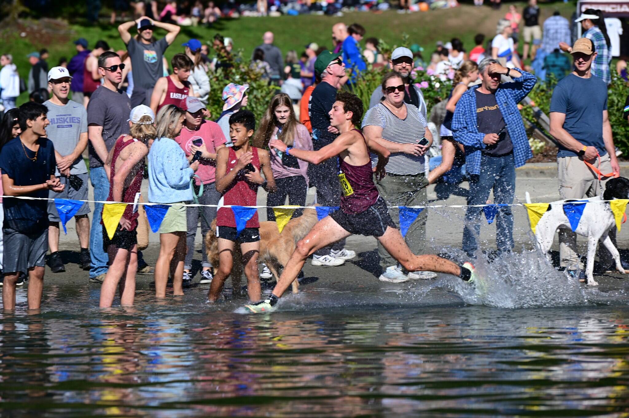 Owen Powell kicks up a splash while running through the lake. Photo courtesy of Aaron Koopman